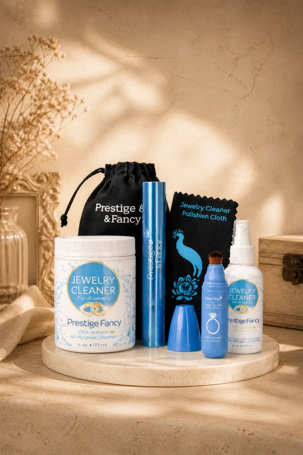 Jewelry cleaning products including a jar, bottles, and cloths on a wooden surface with a decorative background.